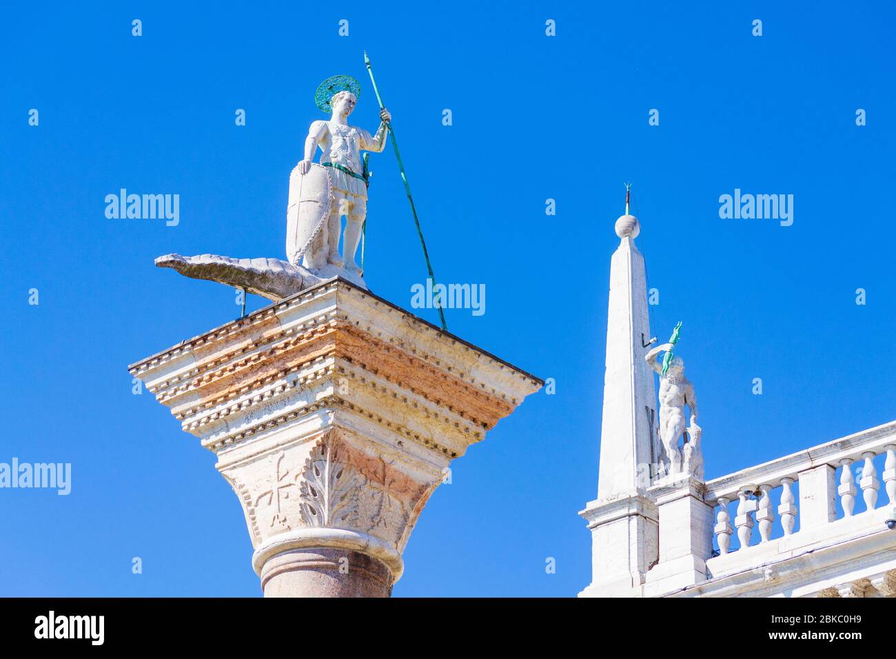 the granite column top carrying one of symbols of the two patron saints
