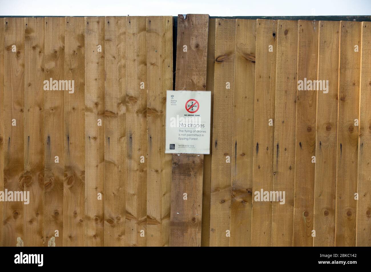 A no drones sign posted on the fence surrounding a temporary mortuary built on open park land at Wanstead Flats in East London during the Coronavirus Stock Photo
