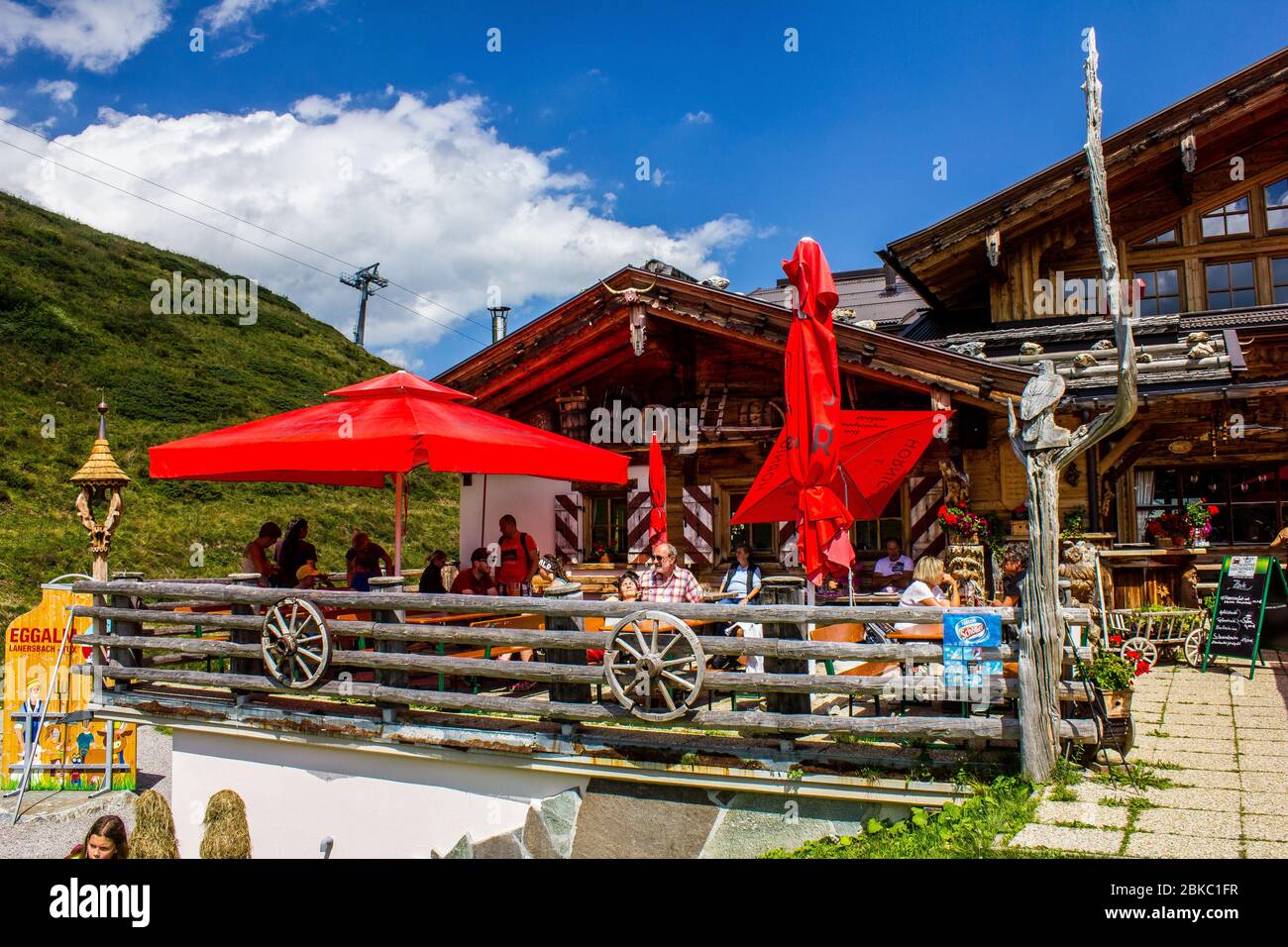 Tux, Austria - August 11, 2019: People Sitting in the Garden of Berggasthaus Eggalm, Tyrol Stock Photo