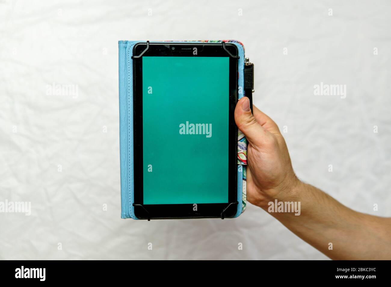 Tablet with green screen in hand on an isolated white background Stock