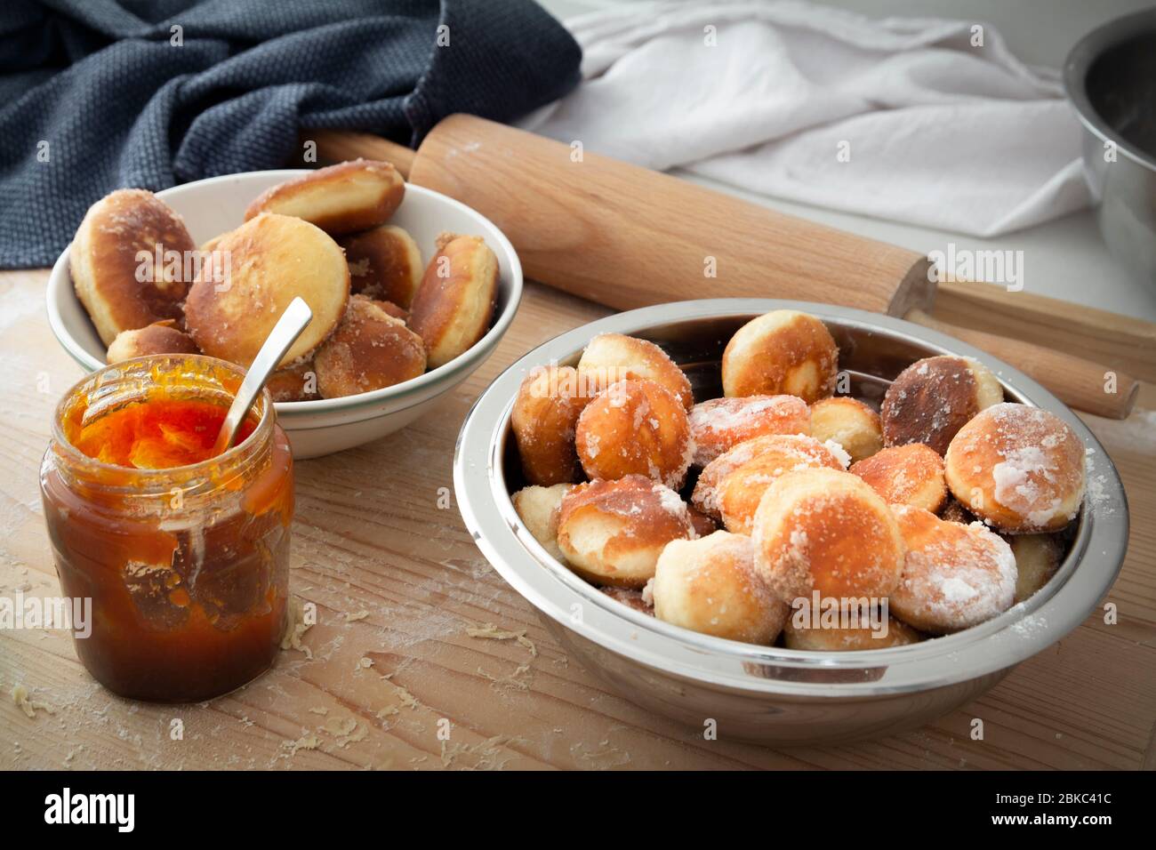 homemade donuts with jam in bowl on wooden table Stock Photo
