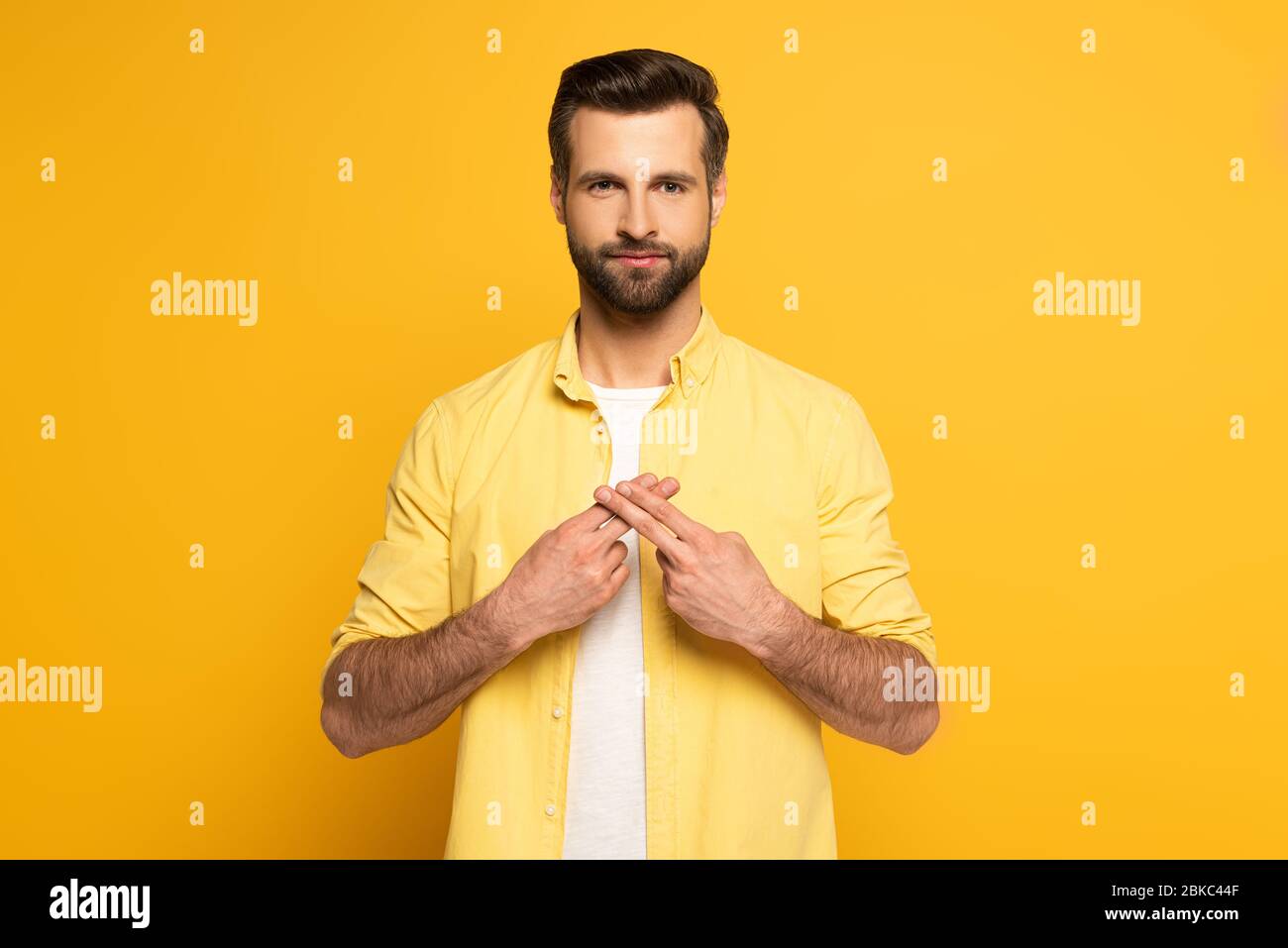 Man using deaf and dumb language on yellow background Stock Photo