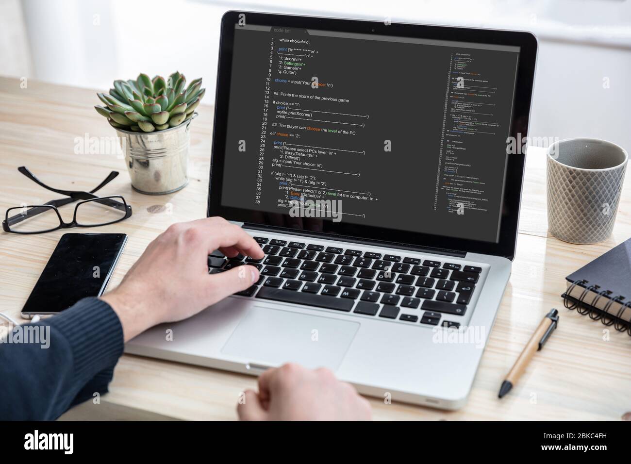 Computer code, software concept. Programmer working with a laptop,  programming code on the screen, office background. Developing coding  technologies Stock Photo - Alamy