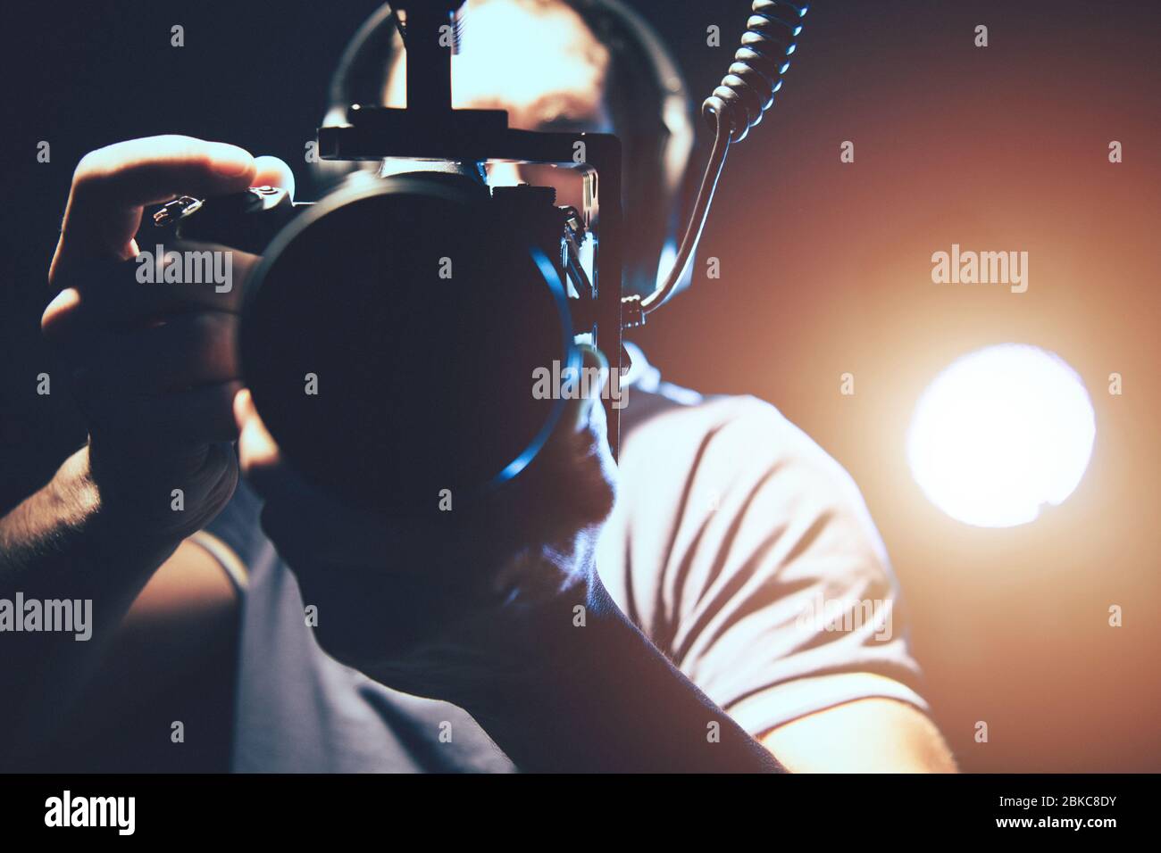 Videographer with Professional DSLR Camera in Hands Taking Handheld