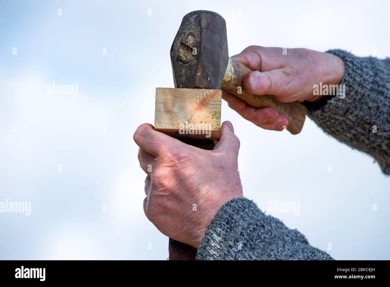 Hammer and hand handle on the wooden post Stock Photo Alamy