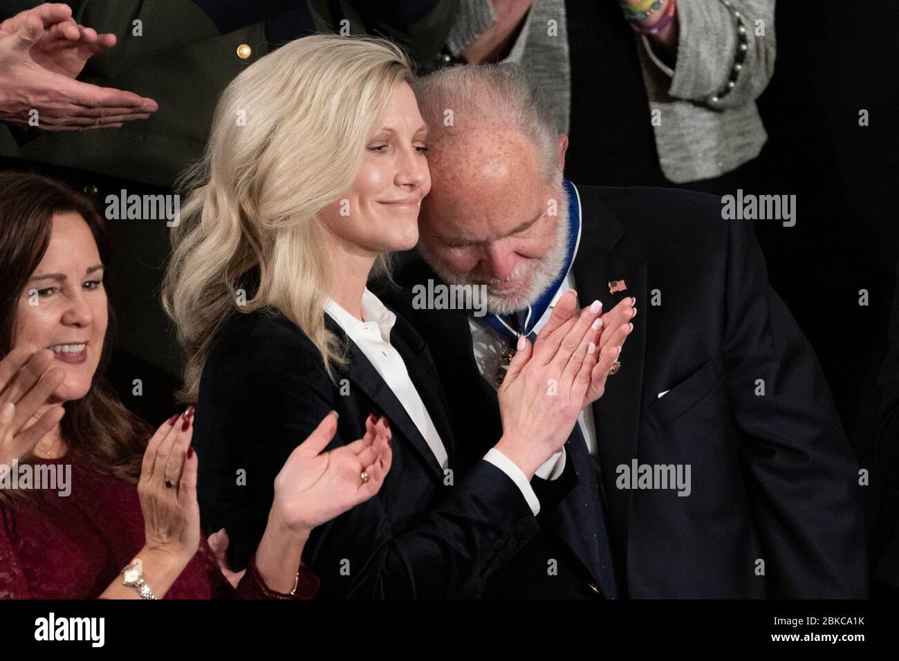 Rush Limbaugh embraces his wife Kathryn Adams Limbaugh in the House Guests Gallery Tuesday evening, Feb. 4, 2020, as President Donald J. Trump announces he is presenting Limbaugh with the Medal of Freedom during the State of the Union address at the U.S. Capitol in Washington, D.C. State of the Union 2020 Stock Photo