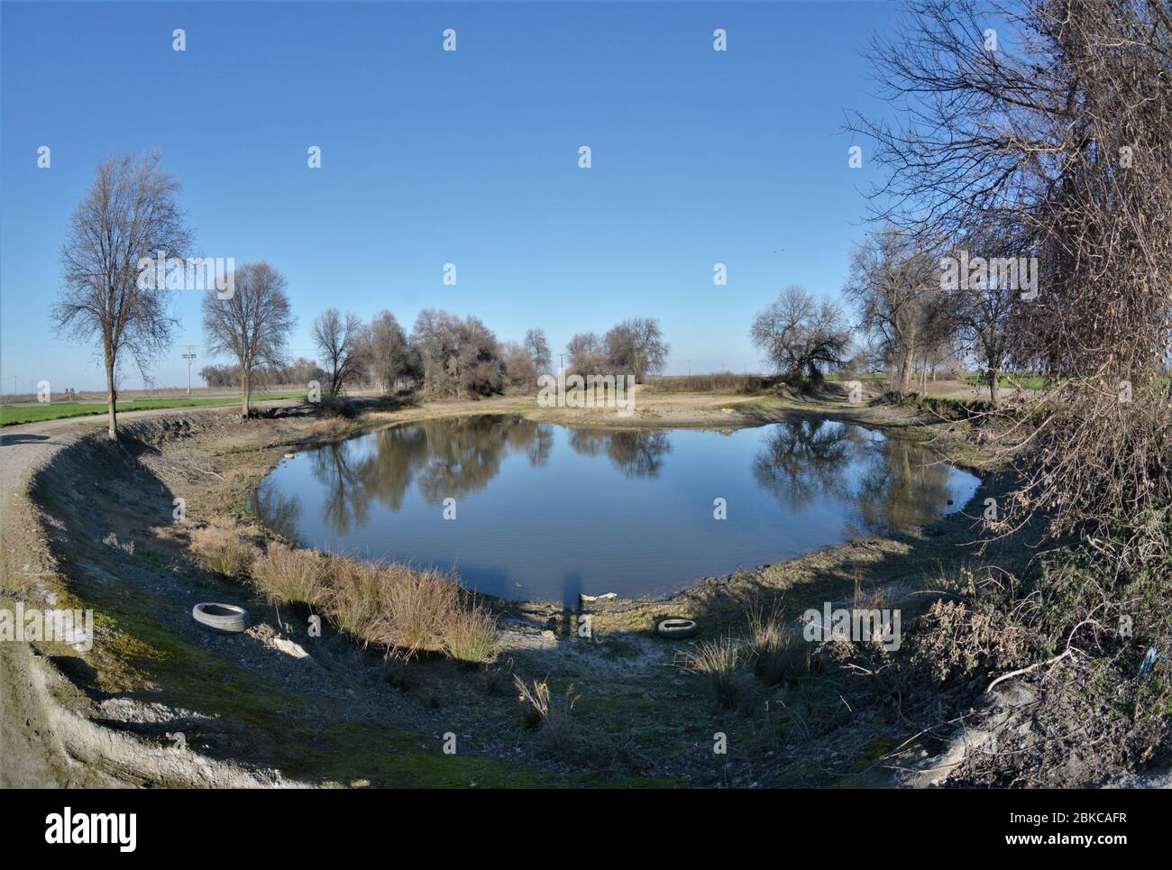 Water retention pond in the central valley of California in the time of ongoing drought in the farming community - no rainwater being saved Stock Photo