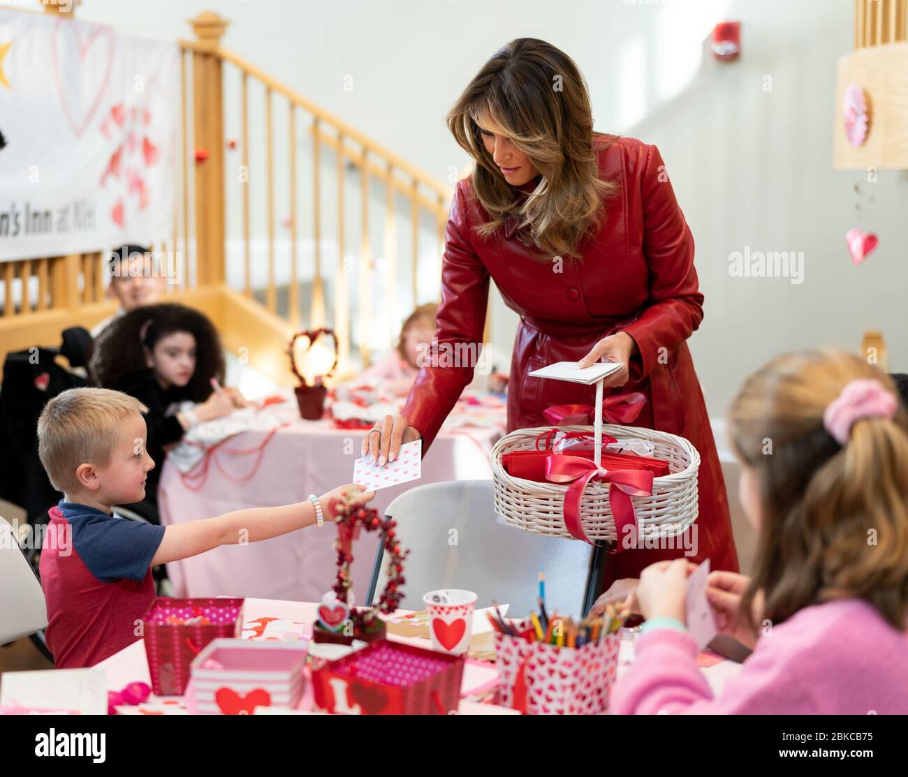 First Lady Melania Trump receives a valentine card from 7 year-old patient Hunter Chaplin of Dinwiddie, Va. during a Valentine’s Day visit Friday, Feb. 14, 2020, at the Children’s Inn at the National institute of Health in Bethesda, Md. First Lady Melania Trump Visits the Children’s Inn at the National Institute of Health Stock Photo