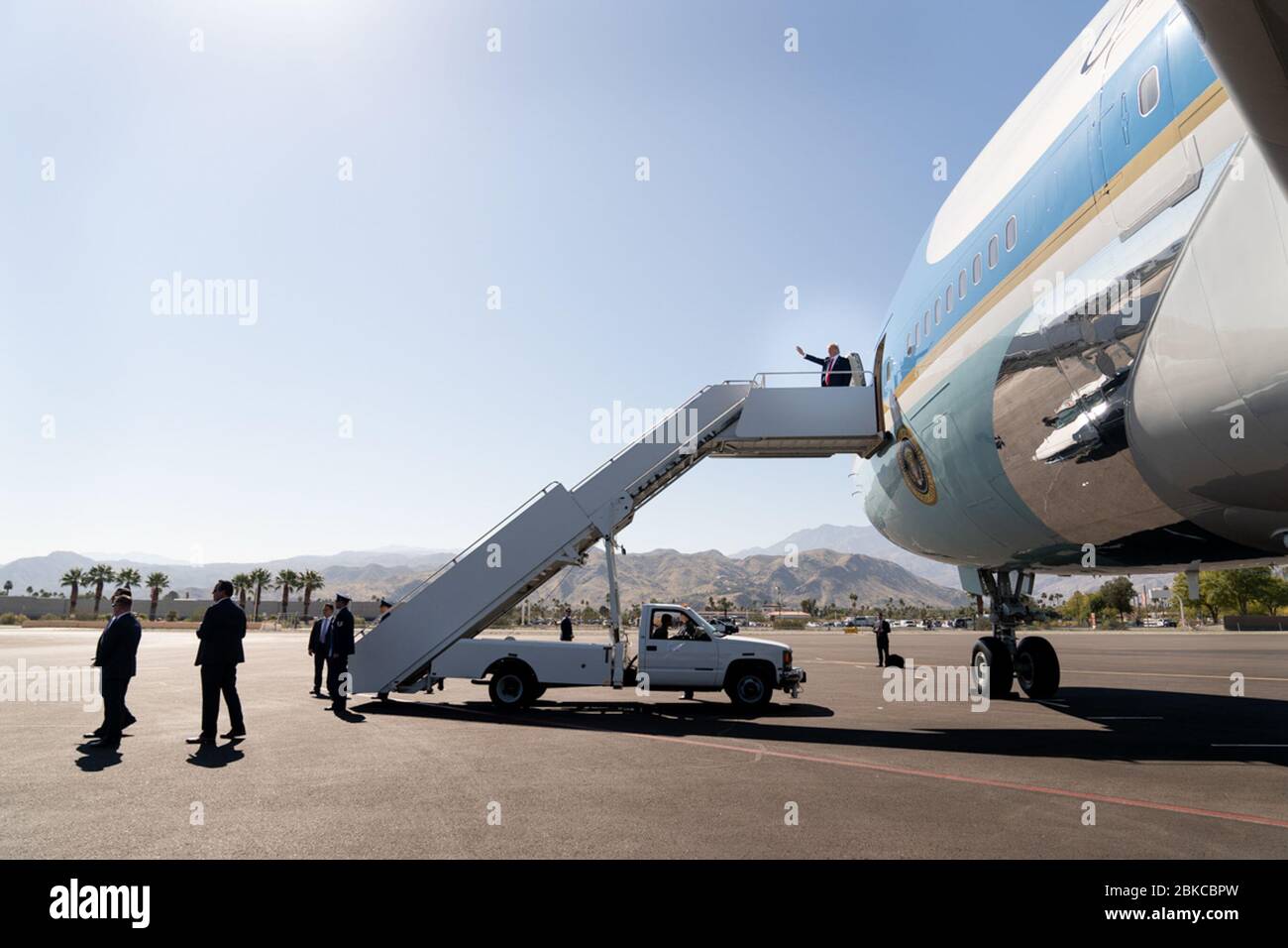 President Donald J. Trump waves as he disembarks Air Force One at Palm Spring International Airport in Palm Springs, Calif. Wednesday, Feb. 19, 2020, en route to an event at the Porcupine Creek Golf Course in Rancho Mirage, Calif. President Trump in CA Stock Photo