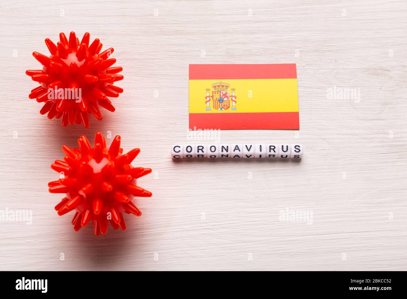 Abstract virus strain model of 2019-nCoV middle East respiratory syndrome coronavirus or coronavirus COVID-19 with text and flag Spain on white Stock Photo