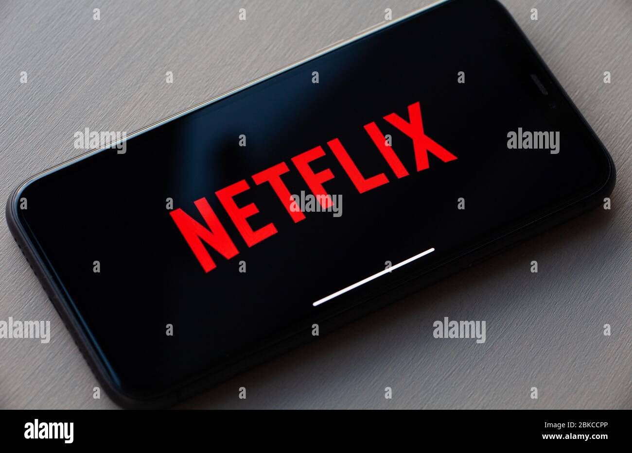 Netflix logo on Apple iPhone 11. Netflix is a global provider of streaming movies and TV series. Stock Photo