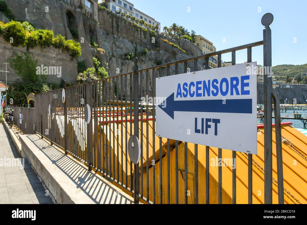 SORRENTO, ITALY - AUGUST 2019: Sign showing visitors the way to the elevator which takes people up to the town which is on top of the cliffs Stock Photo