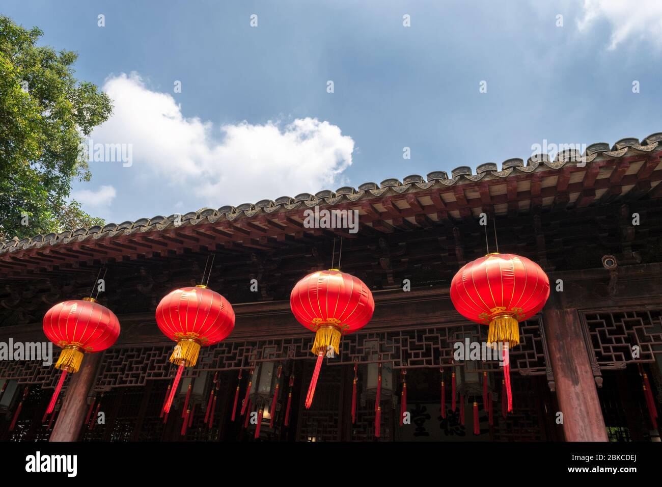 Red lanterns, symbols of vitality and good luck, hanging from the roof of old traditional style Chinese residence (Siheyuan) Stock Photo