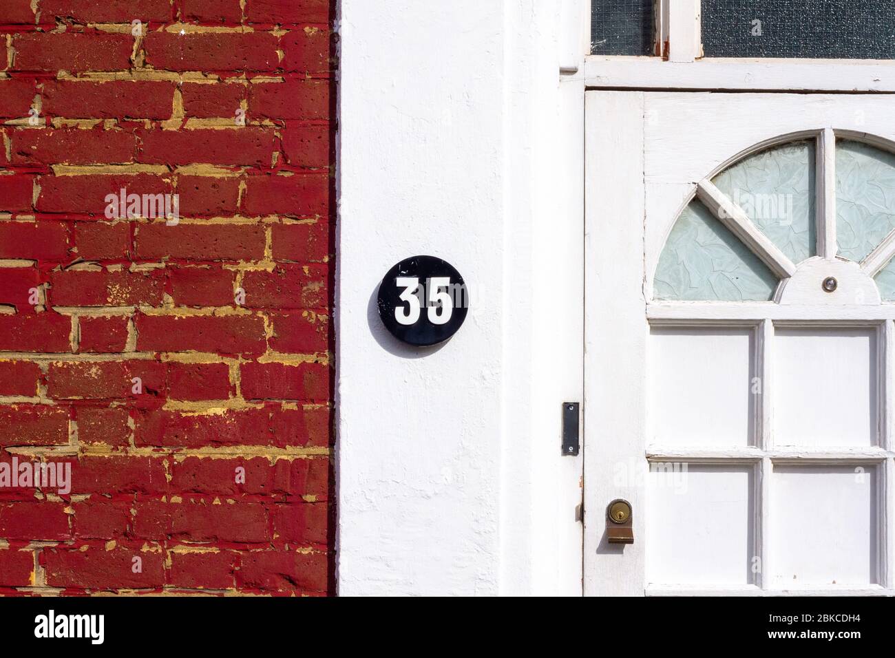 House number 35 on a white house wall Stock Photo
