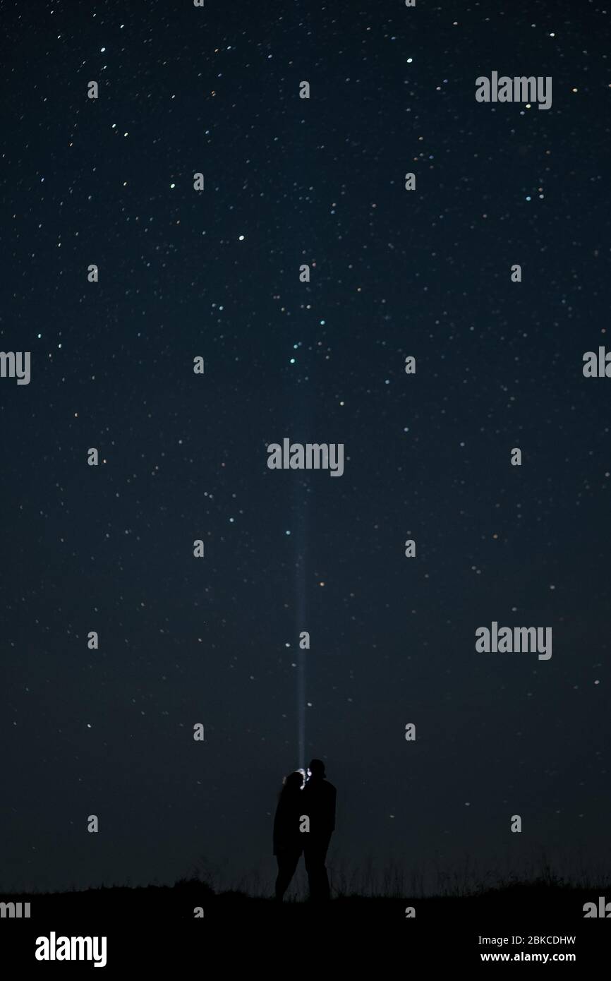 Couple in love standing together under the starry sky Stock Photo - Alamy