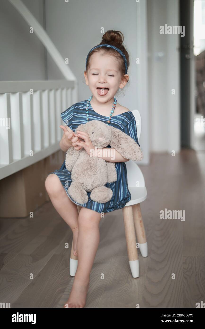 Adorable little girl in a blue dress Stock Photo - Alamy