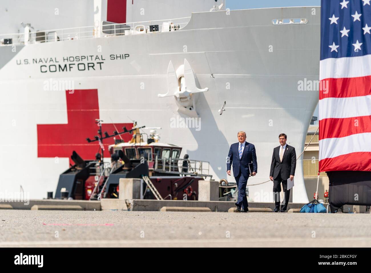 President Donald J. Trump, joined by Secretary of Defense Mark Esper, arrives at Naval Air Station Norfolk Pier 8, Saturday, March 28, 2020, where they will each deliver remarks prior to the departure of the USNS Comfort, a U.S. Navy hospital ship stationed in Norfolk, Virginia. President Trump at Naval Air Station Norfolk Stock Photo