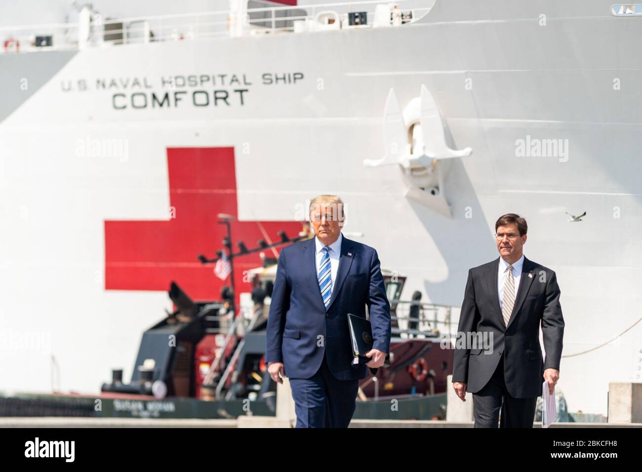 President Donald J. Trump, joined by Secretary of Defense Mark Esper, arrives at Naval Air Station Norfolk Pier 8, Saturday, March 28, 2020, where they will each deliver remarks prior to the departure of the USNS Comfort, a U.S. Navy hospital ship stationed in Norfolk, Virginia. President Trump at Naval Air Station Norfolk Stock Photo