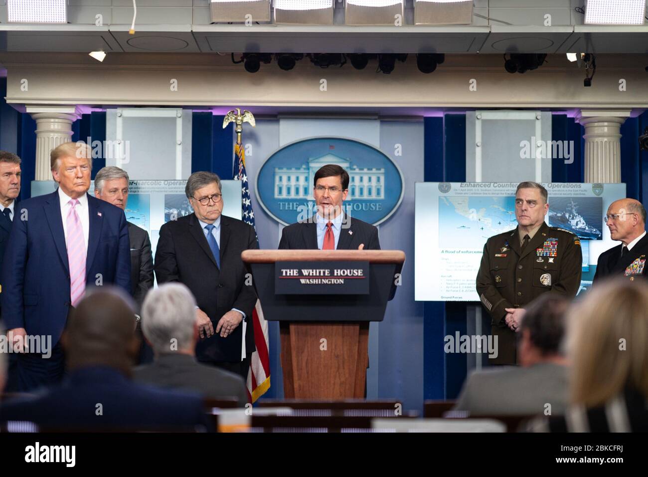 President Donald J. Trump listens as Secretary of Defense Mark Esper delivers remarks at a briefing Tuesday, March 31, 2020, in the James S. Brady Press Briefing Room of the White House. White House Coronavirus Update Briefing Stock Photo