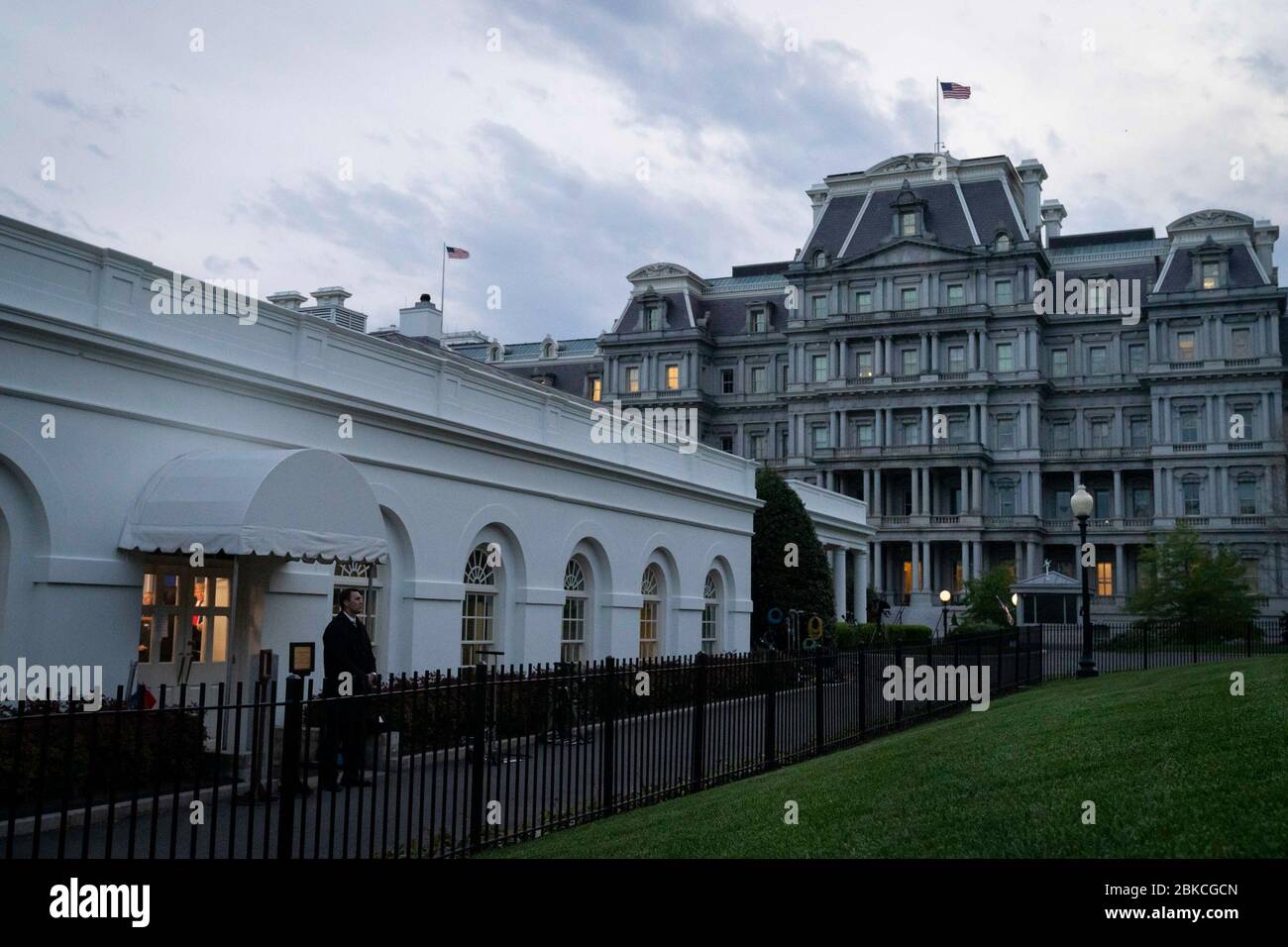 President Donald J. Trump is seen through the door window as he delivers remarks and talks to members of the press Friday, April 17, 2020, inside the James S. Brady White House Press Briefing Room of the White House. White House Coronavirus Update Briefing Stock Photo