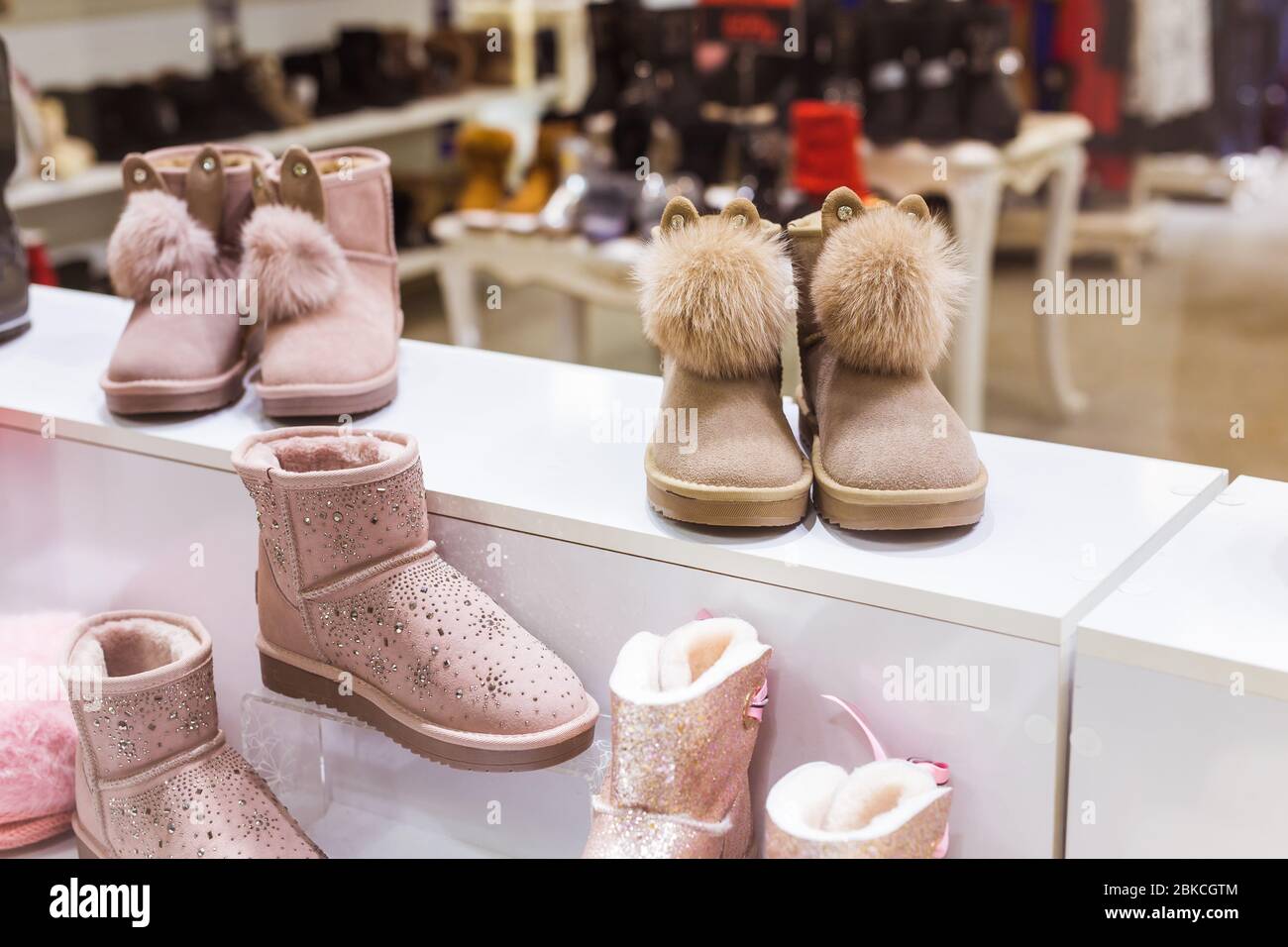 Pink Ugg in the shop window, female winter warm shoes. Winter clothes,  fashion and cold season concept Stock Photo - Alamy