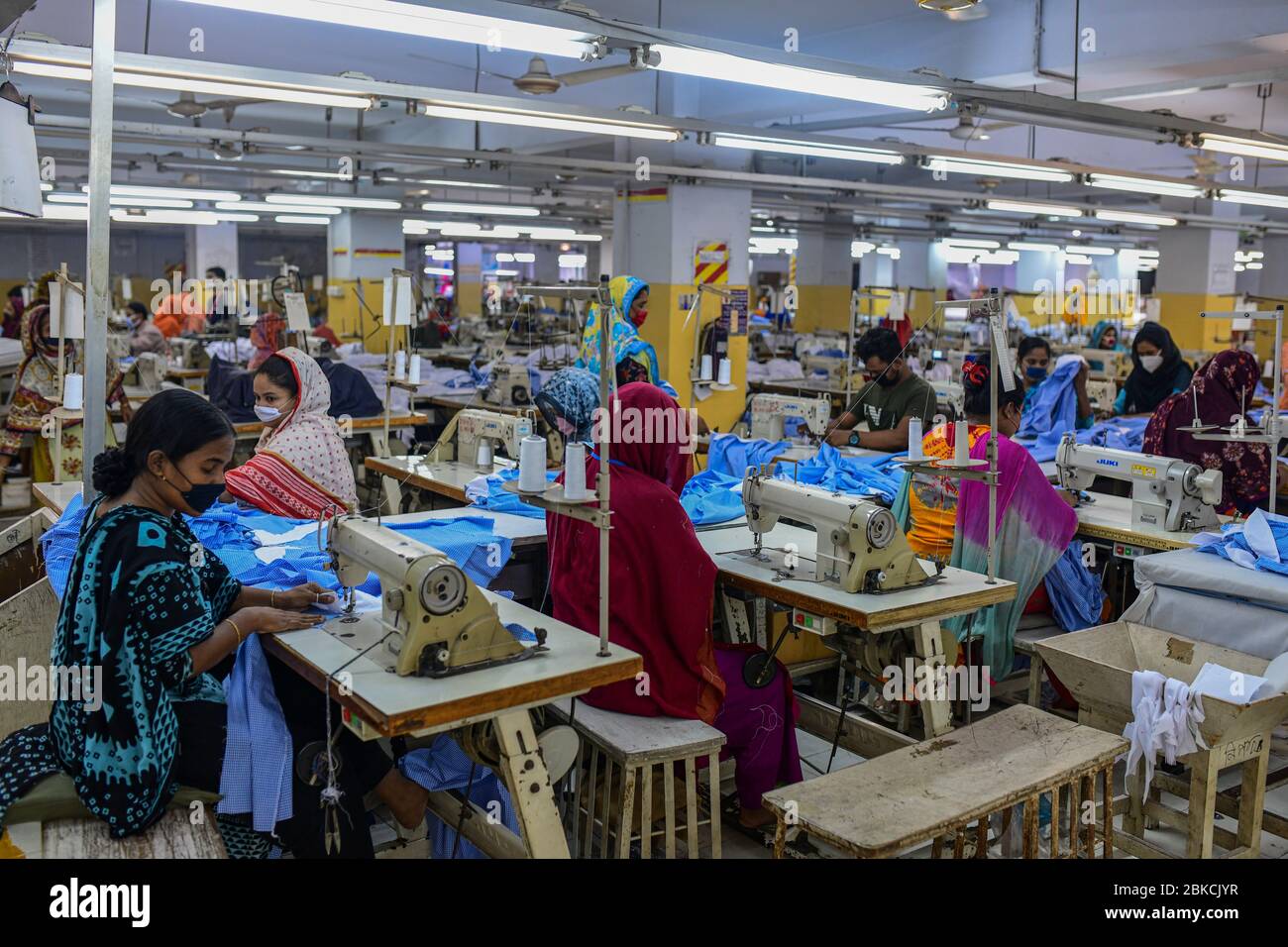 Laborer’s work in a garment factory, as factories reopened after the government has eased the restrictions amid concerns over coronavirus disease (COVID-19) outbreak in Dhaka, Bangladesh, May 03, 2020. Stock Photo
