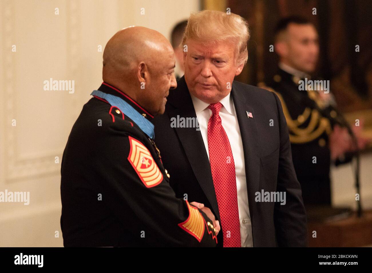 President Donald J. Trump presents the Medal of Honor to retired U.S. Marine Sgt. Maj. John Canley Wednesday, Oct. 17, 2018, in the East Room of the White House. President Donald J. Trump Presents the Medal of Honor Stock Photo
