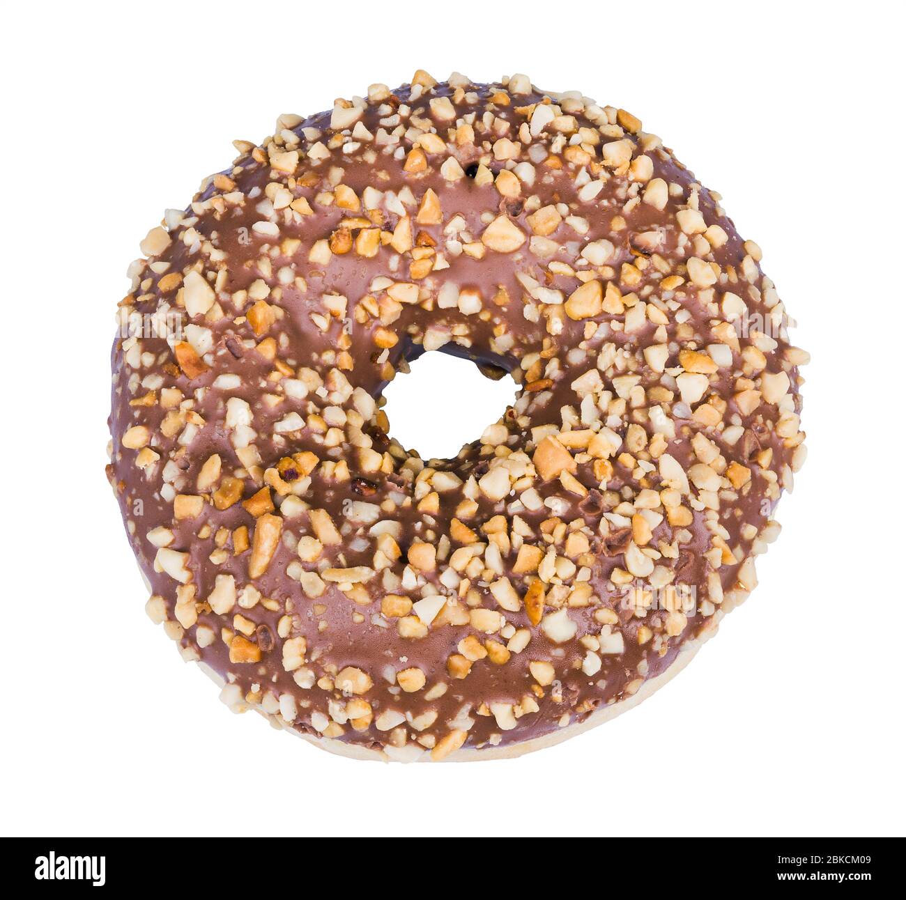 Baked donut decorated with nougat icing and crushed nuts isolated on white background. One sweet doughnut with round hole, cocoa glaze and nut pieces. Stock Photo
