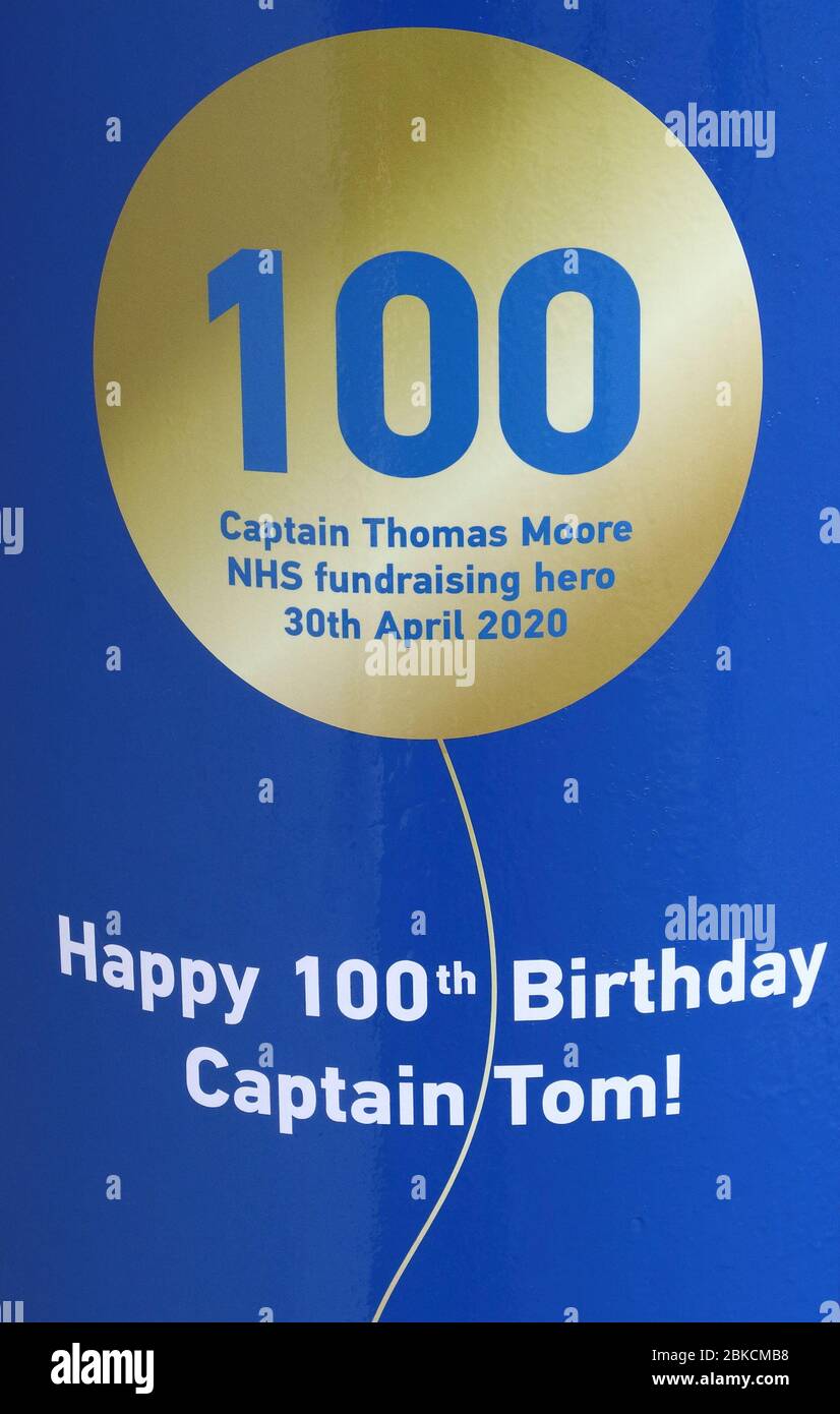 Birthday message on a blue Postbox outside Village Post office in Marson Moretaine.Royal Mail celebrated Captain Tom Moore’s 100th birthday with a special postbox in honour of his incredible efforts to raise money for the NHS (National Health Services). The postbox is painted NHS blue and includes a gold balloon and birthday greetings. His fantastic fundraising effort has reached the £32 million mark for the NHS, and he has become a symbol of hope and unity across the UK and beyond during these uncertain times. Stock Photo