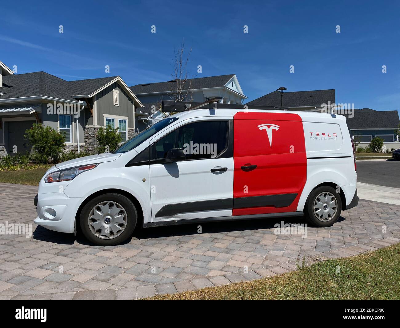 Orlando, FL/USA4/1/20 A Tesla repair truck in the driveway of a Tesla Model 3 owner repairing