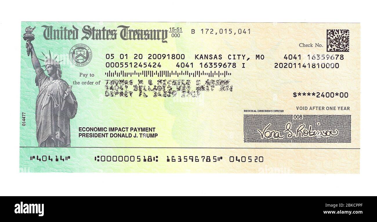 This is a close-up of an actual check for $2400.00 issued by the United States Treasury to a married couple in payment for the negative economic impact to residents of the U.S. caused by the novel coronavirus disease commonly known as COVID-19. The American Congress voted in early 2020 to make a one-time payment of $1,200.00 to every eligible adult as part of the government’s economic relief package to stave off the effects of the coronavirus pandemic. Unprecedented and controversial was the decision by the Treasury Department to print 'President Donald J. Trump' on each check . Stock Photo