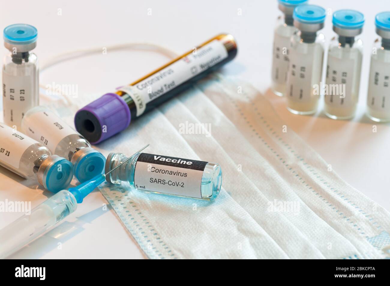Medical syringe with glass ampoule vial with coronavirus COVID-19 vaccine. Stock Photo