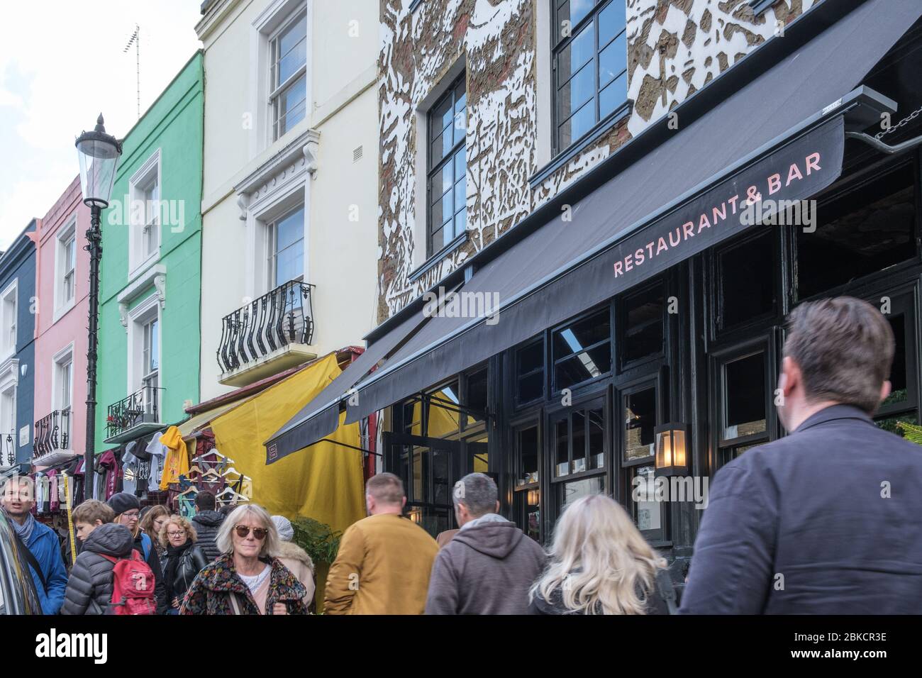 Portobello Road, crowded with people shopping in front of Gold