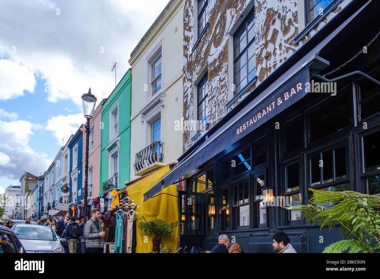Portobello Road, crowded with people shopping & dining at Gold