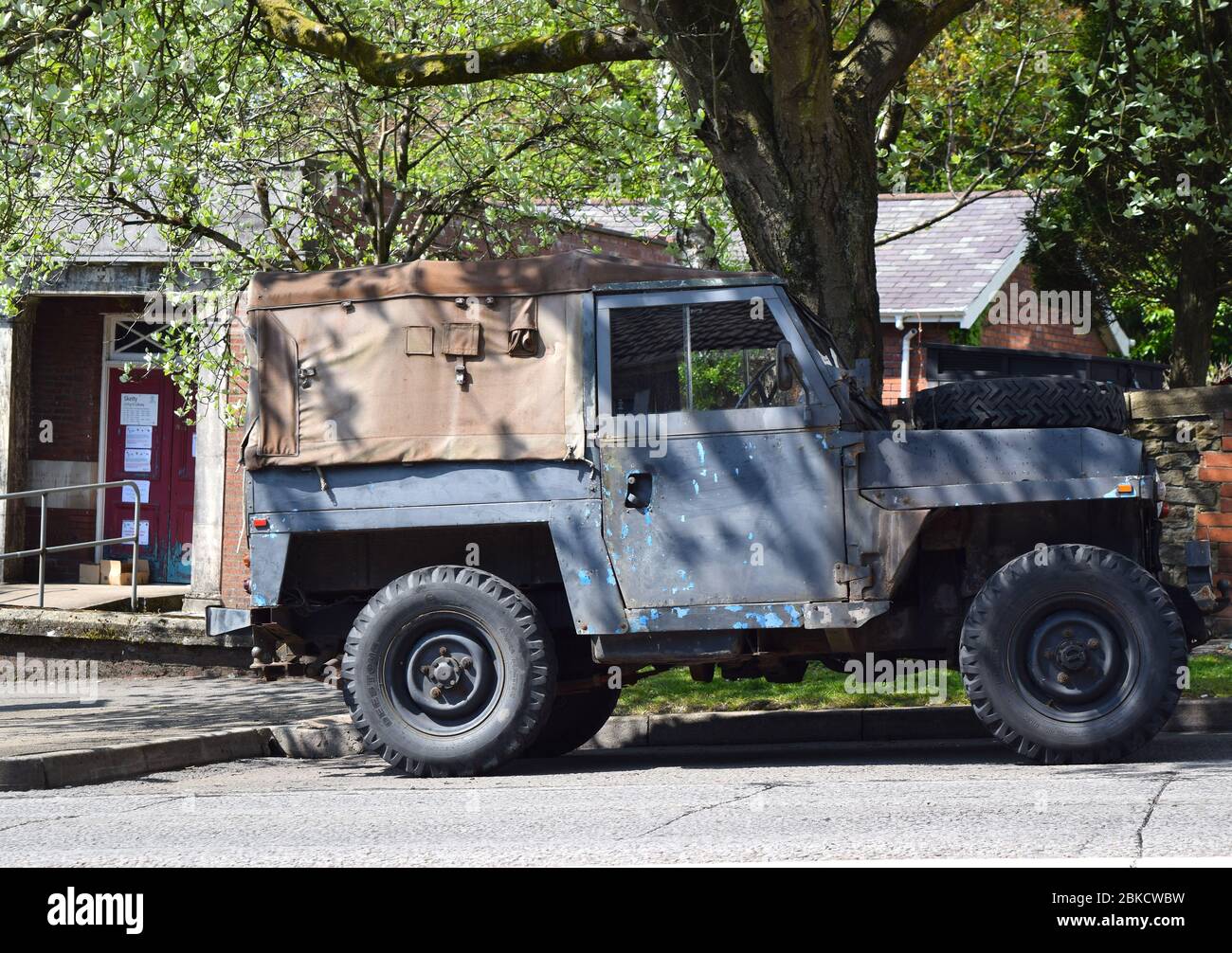 Old Land Rover car parked on the residential street on a sunny day. Stock Photo