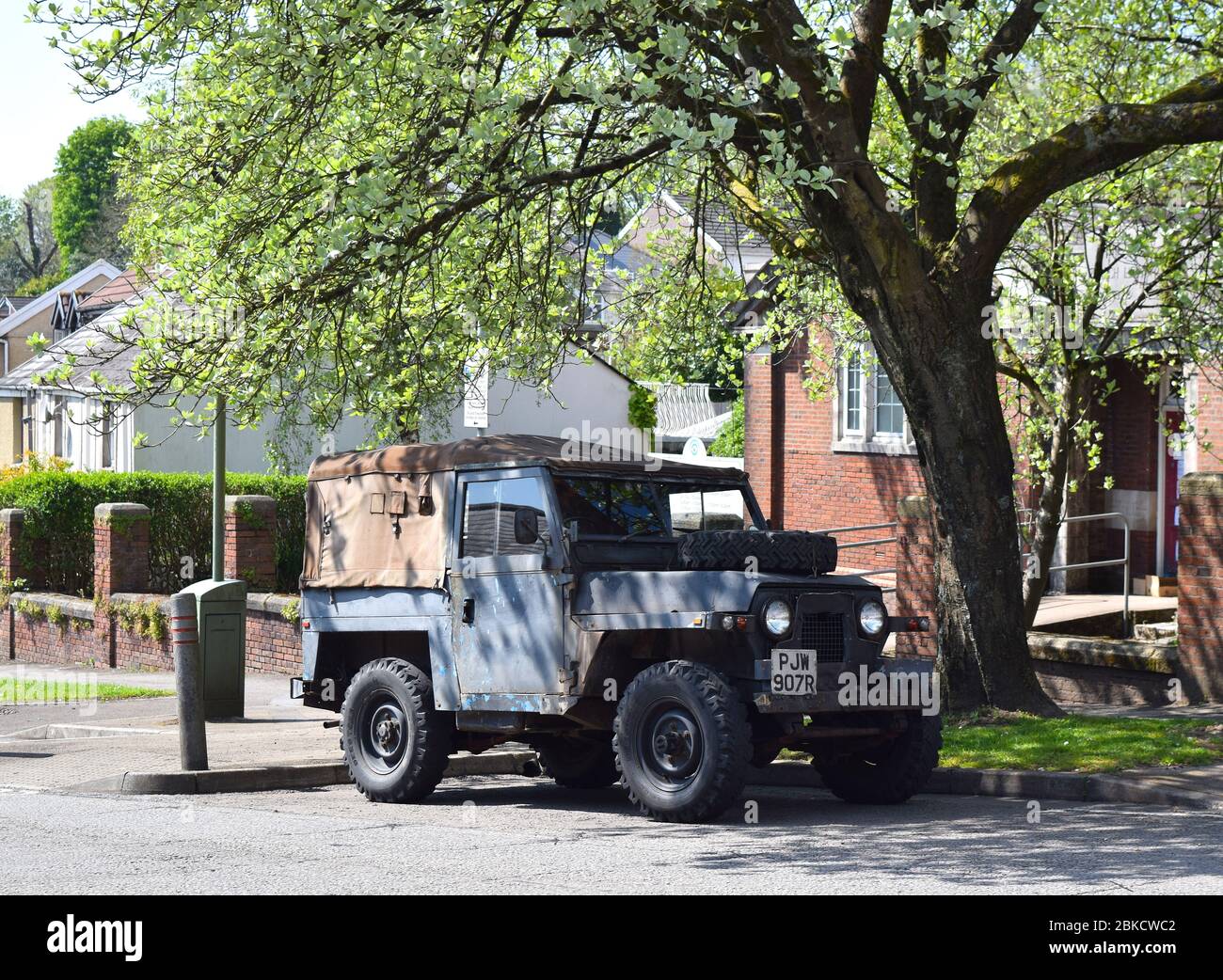 Old Land Rover car parked on the residential street on a sunny day. Stock Photo