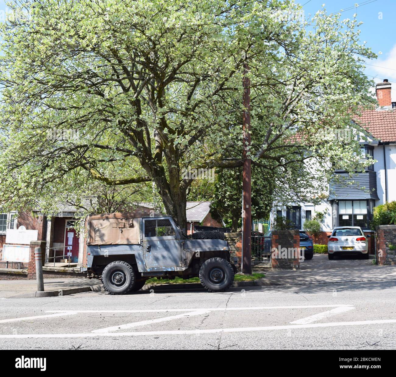 Old Land Rover car parked on the residential street on a sunny day. Stock Photo