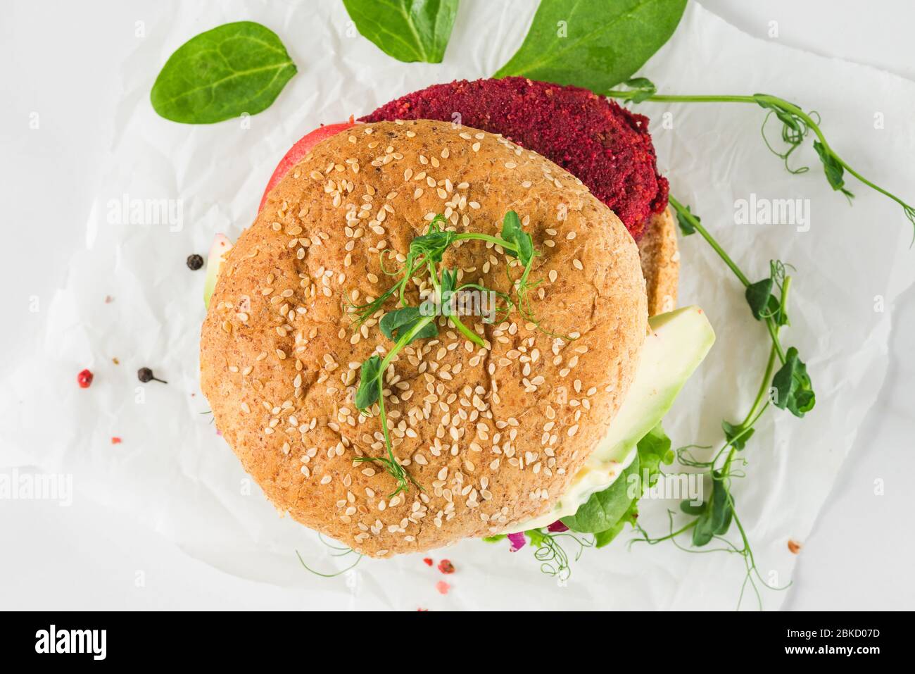 Veggie burger with beetroot and avocado on white marble table. Healthy vegan food. top view Stock Photo