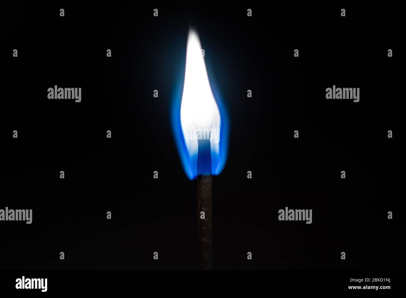 Burning match lighting flame isolated on a black background Stock Photo