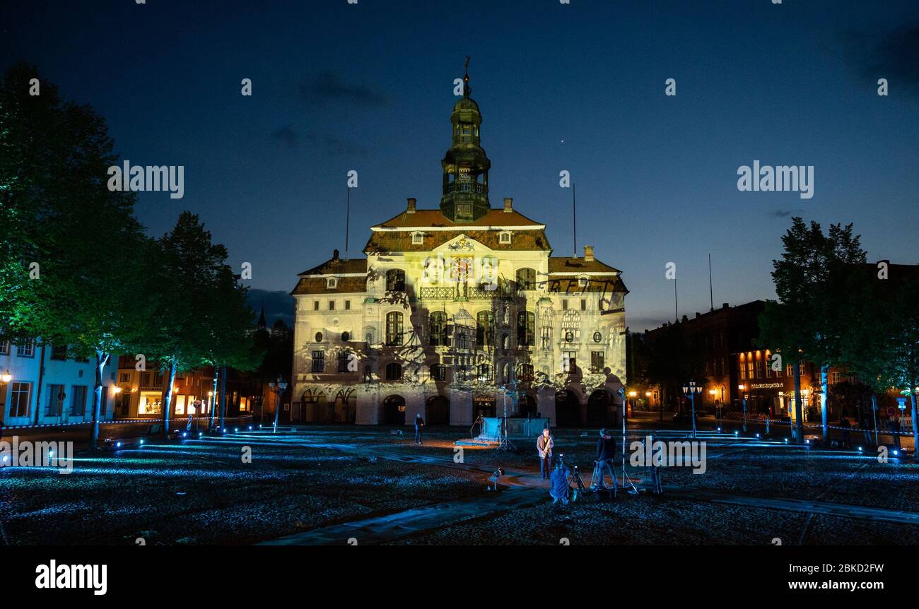03 May 2020, Lower Saxony, Lüneburg: The town hall of Lüneburg is illuminated by projectors on the occasion of the 75th anniversary of the capitulation of northwest Germany. Photo: Philipp Schulze/dpa Stock Photo
