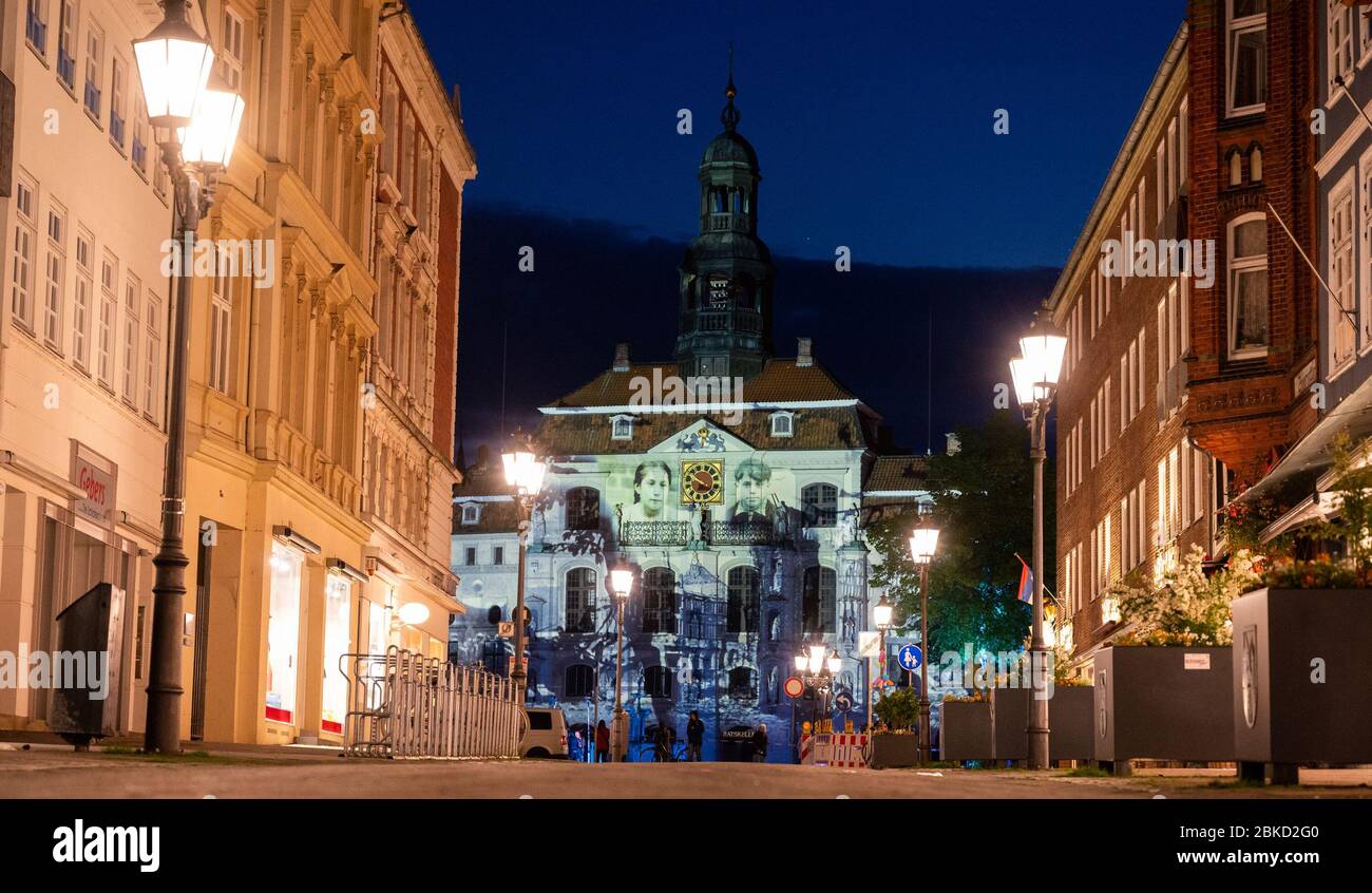 03 May 2020, Lower Saxony, Lüneburg: The town hall of Lüneburg is illuminated by projectors on the occasion of the 75th anniversary of the capitulation of northwest Germany. Photo: Philipp Schulze/dpa Stock Photo