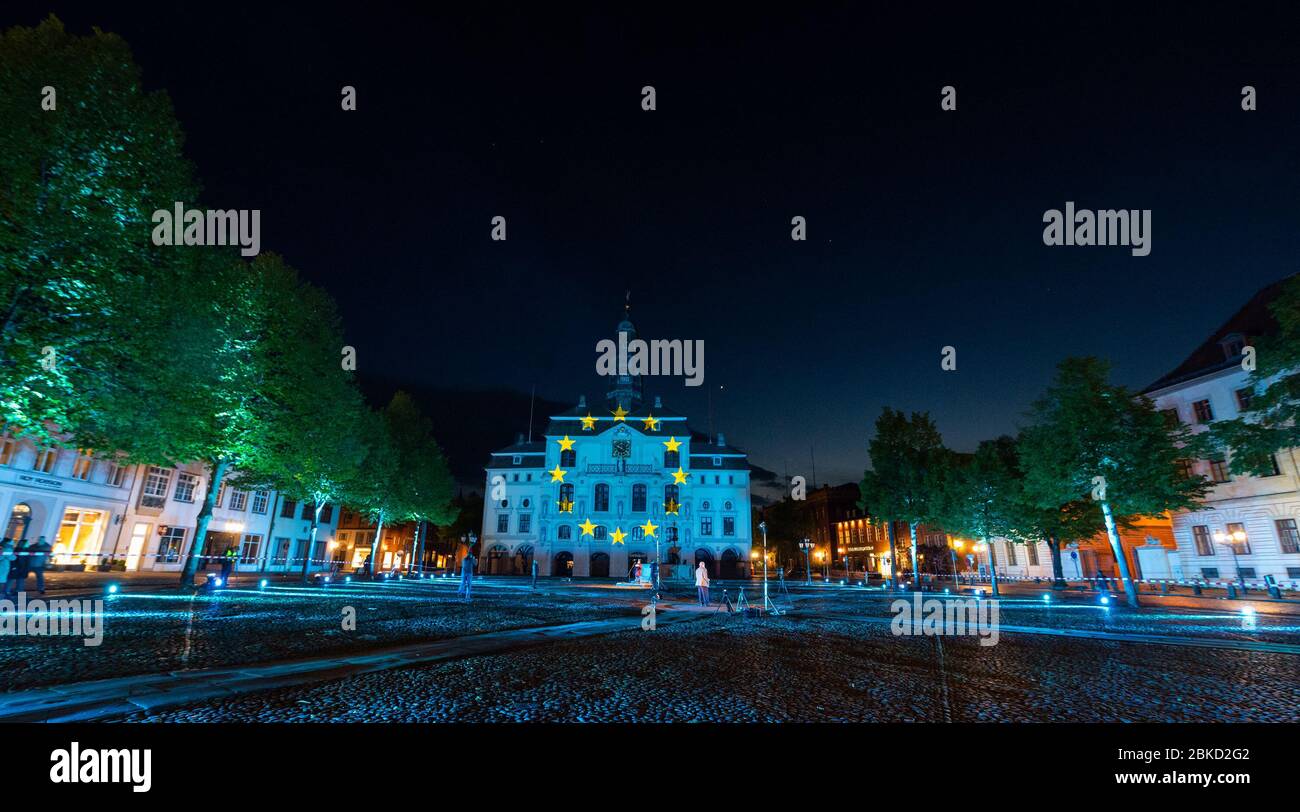 03 May 2020, Lower Saxony, Lüneburg: The town hall of Lüneburg is illuminated by projectors on the occasion of the 75th anniversary of the capitulation of northwest Germany. Photo: Philipp Schulze/dpa Stock Photo