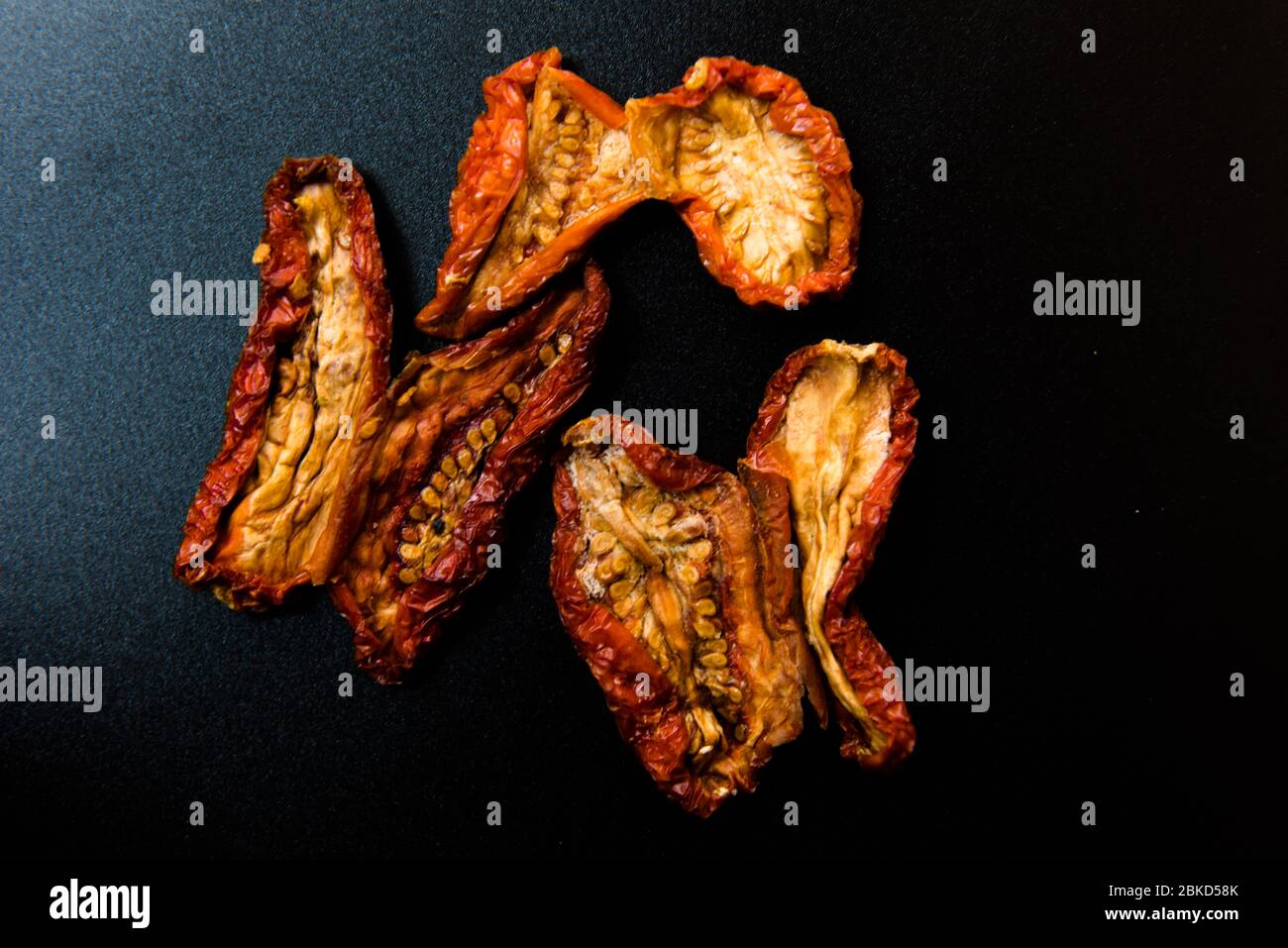 Sun dried tomatoes on a black background Stock Photo