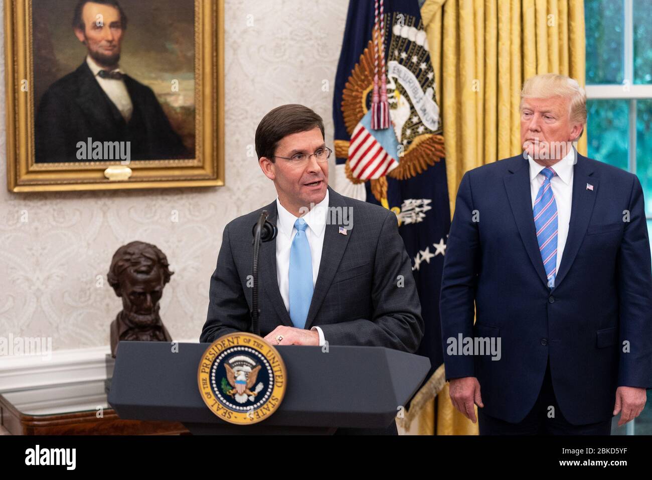 President Donald J. Trump watches as new Secretary of Defense Mark Esper delivers remarks Tuesday, July 23, 2019, in the Oval Office of the White House. Swearing-in Ceremony for Secretary of Defense Mark Esper Stock Photo