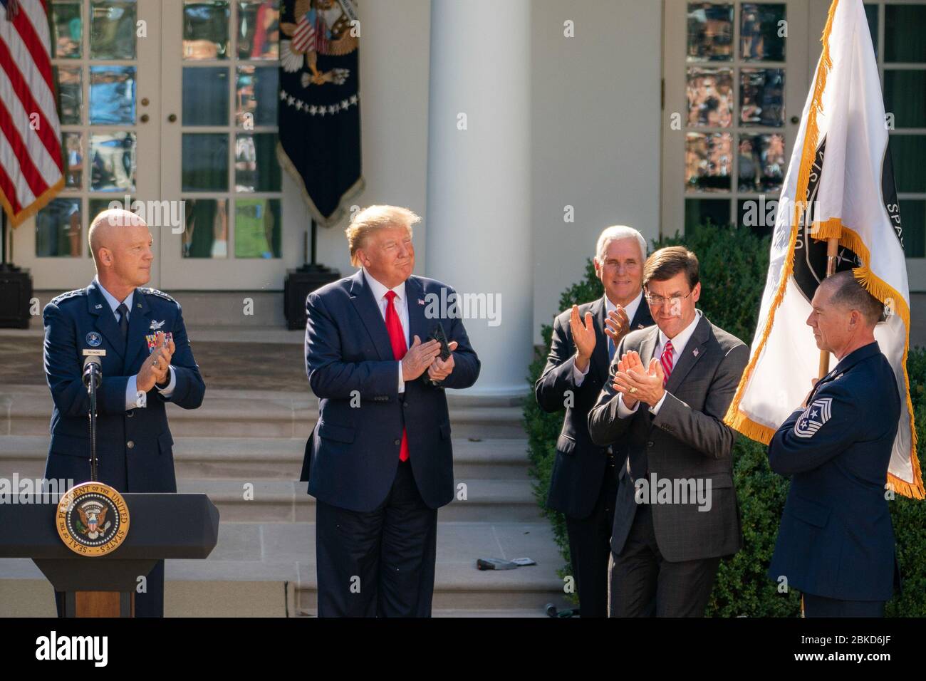 President Donald J. Trump, joined by Vice President Mike Pence, General John ”Jay” Raymond Commander of USSPACECOM, and Secretary of Defense Mark Esper as the flag of the U.S. Space Command (USSPACECOM) is unfurled by CCMSgt Roger Towberman Thursday, Aug. 29, 2019, in the Rose Garden of the White House. The Establishment of the U.S. Space Command Stock Photo