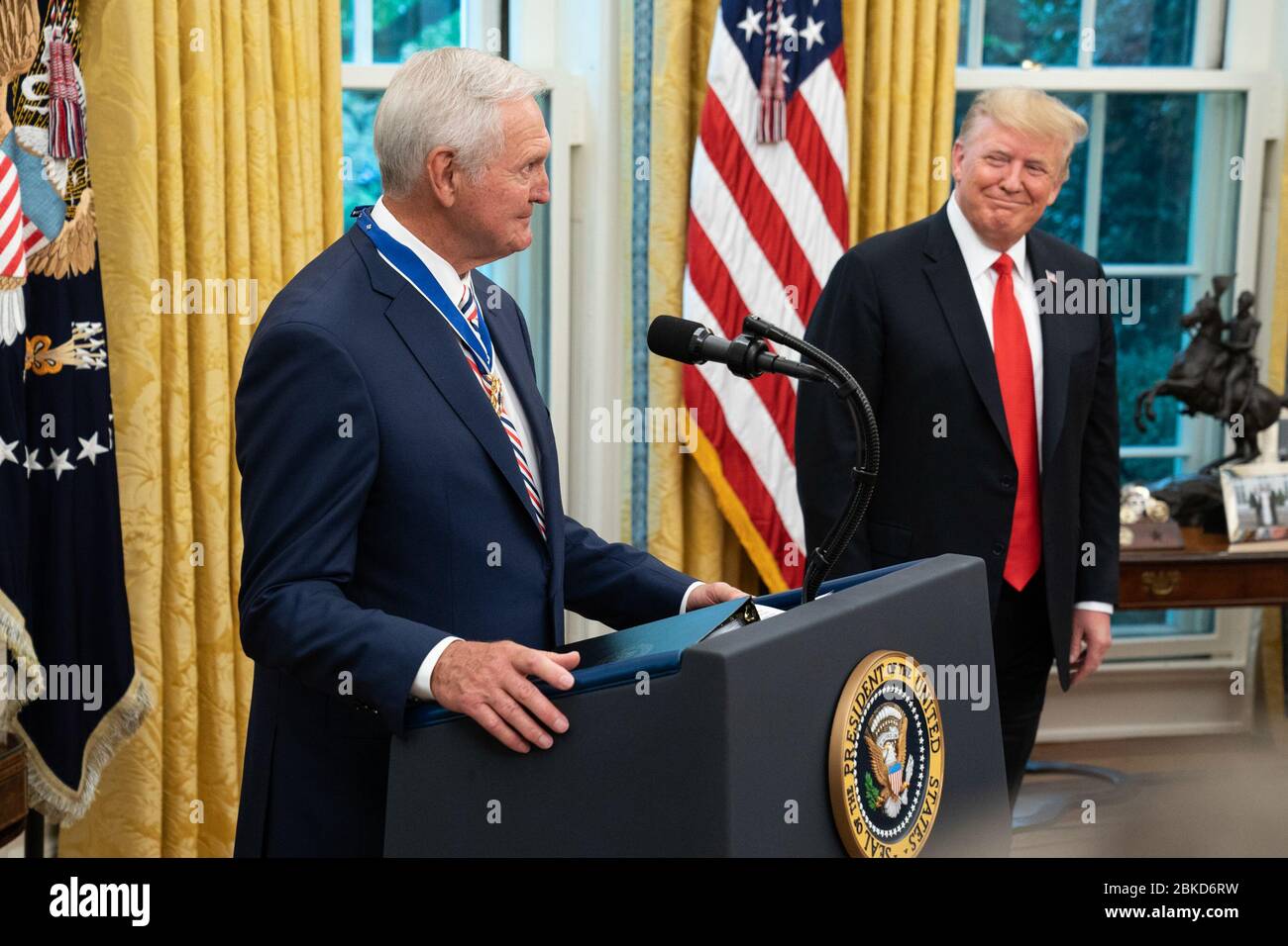 President Donald J. Trump listens as Presidential Medal of Freedom recipient Hall of Fame Los Angeles Lakers basketball star and legendary NBA General Manager Jerry West delivers remarks Thursday, Sept. 5, 2019, in the Oval Office of the White House. President Trump Presents the Medal of Freedom to Jerry West Stock Photo