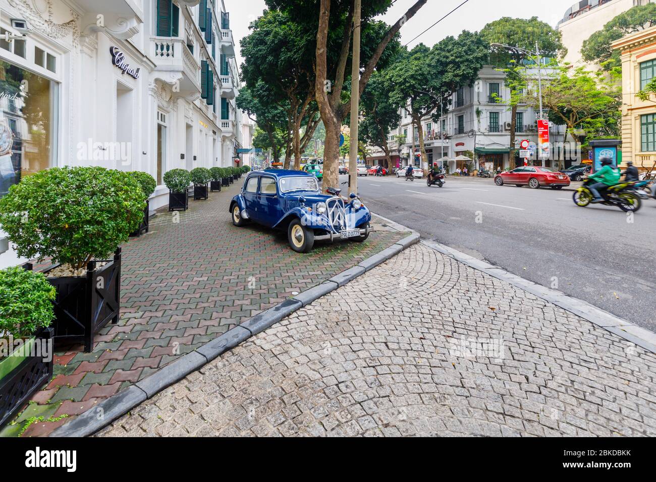 Blue vintage Citroen Traction Avant 15 classic car parked on the pavement outside the Sofitel Legend Metropole Hanoi hotel, Hanoi, north Vietnam Stock Photo