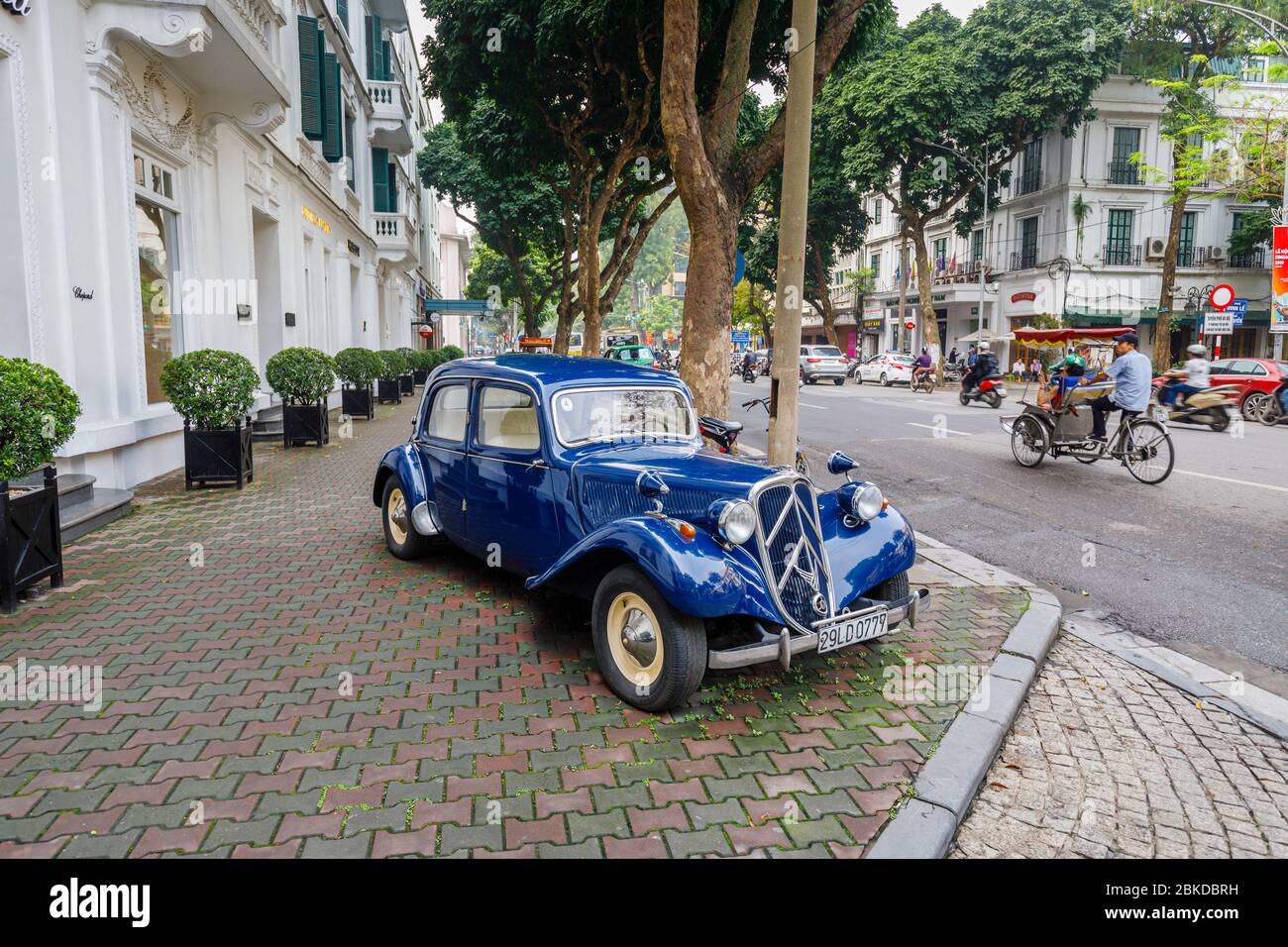 Blue vintage Citroen Traction Avant 15 classic car parked on the pavement outside the Sofitel Legend Metropole Hanoi hotel, Hanoi, north Vietnam Stock Photo