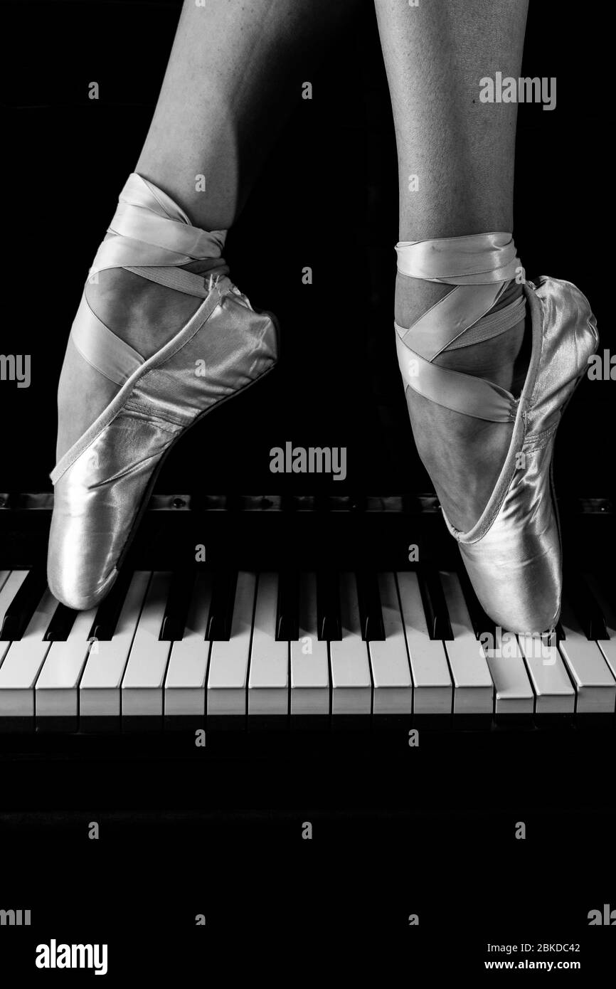 Legs of a ballerina on a piano walking and dancing Stock Photo