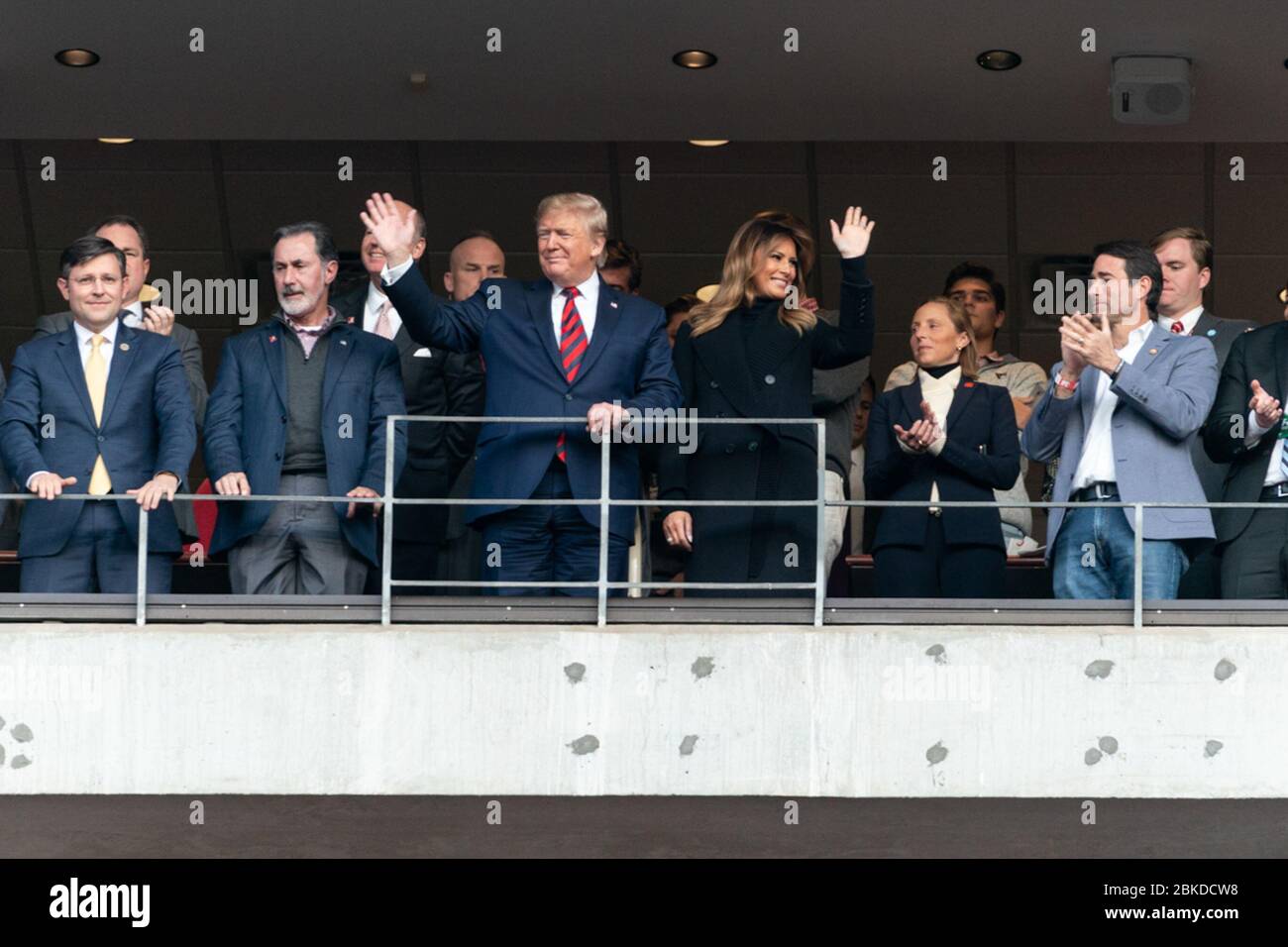 President Donald J. Trump and First Lady Melania Trump joined by guests acknowledge the cheers from the crowd at Bryant-Denny Stadium Saturday, Nov. 9, 2019, while attending the University of Alabama -Louisiana State University football game in Tuscaloosa, Ala. President Trump and First Lady Melania Trump in Alabama Stock Photo